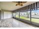 Screened lanai with a ceiling fan offering views of the backyard and surrounding neighborhood at 2263 Citrus Ct, Clearwater, FL 33763