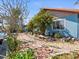 Beautiful backyard with a brick walkway and lush tropical landscaping and water view at 2300 S Shore Se Dr, St Petersburg, FL 33705