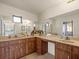 Well-lit bathroom featuring dual sinks with ample counter space and wooden cabinets at 2300 S Shore Se Dr, St Petersburg, FL 33705
