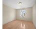 Bright bedroom featuring a window with sheer curtains and hardwood flooring at 2300 S Shore Se Dr, St Petersburg, FL 33705