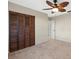 Bedroom features closet with louvered doors and decorative ceiling fan at 2300 S Shore Se Dr, St Petersburg, FL 33705