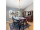 Cozy dining room featuring a chandelier, window with curtains, and classic furniture at 2300 S Shore Se Dr, St Petersburg, FL 33705