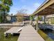Exterior view of a waterfront property with lush greenery and a private dock at 2300 S Shore Se Dr, St Petersburg, FL 33705