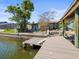Exterior view of a waterfront property with lush greenery and a private dock at 2300 S Shore Se Dr, St Petersburg, FL 33705