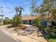 Charming single-story home with lush landscaping, a tiled roof and a paved driveway at 2300 S Shore Se Dr, St Petersburg, FL 33705