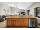 Open-concept kitchen featuring granite countertops, wood cabinetry, and an integrated bar area at 2300 S Shore Se Dr, St Petersburg, FL 33705