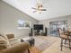 Large living room area with ceiling fan and access to the lanai through glass doors at 2300 S Shore Se Dr, St Petersburg, FL 33705