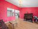 Living room features red walls, an ornate chandelier and hardwood floors throughout at 2300 S Shore Se Dr, St Petersburg, FL 33705