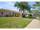 Spacious backyard with palm trees, lawn, patio, and walkway at 2348 Rolling View Dr, Spring Hill, FL 34606