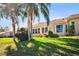 Home's backyard showing well-maintained lawn, palm trees, and ample sunlight at 2348 Rolling View Dr, Spring Hill, FL 34606