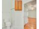 A view from a bathroom into a bedroom with wood-style flooring at 2348 Rolling View Dr, Spring Hill, FL 34606