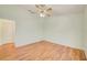 Well-lit bedroom features wood floors, a ceiling fan, and a closet at 2348 Rolling View Dr, Spring Hill, FL 34606