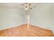 Bright bedroom with wood floors, a ceiling fan, and an open doorway at 2348 Rolling View Dr, Spring Hill, FL 34606