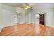 Large bedroom with hardwood floors, fan, and sliding doors to the porch at 2348 Rolling View Dr, Spring Hill, FL 34606