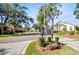 Hillside Village community entrance with lush landscaping, mature trees, and paved pathway at 2348 Rolling View Dr, Spring Hill, FL 34606