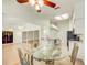Bright dining area featuring a glass table and ornate chairs, adjacent to the kitchen with granite countertops at 2348 Rolling View Dr, Spring Hill, FL 34606