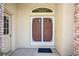 Inviting front door with decorative screen, sidelight, and transom window for lots of natural light at 2348 Rolling View Dr, Spring Hill, FL 34606