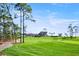Picturesque golf course view with lush green fairways and clubhouse in the background on a sunny day at 2348 Rolling View Dr, Spring Hill, FL 34606