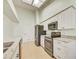 Modern kitchen features white cabinets, granite countertops, and stainless steel appliances under a skylight at 2348 Rolling View Dr, Spring Hill, FL 34606