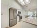 Modern kitchen featuring stainless steel appliances, white cabinets, and granite countertops, providing ample cooking space at 2348 Rolling View Dr, Spring Hill, FL 34606