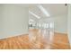 Open-concept living room with vaulted ceilings, skylights, and hardwood floors extending into adjoining rooms at 2348 Rolling View Dr, Spring Hill, FL 34606