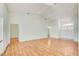 Spacious living room with hardwood floors and neutral wall color to the entryway and adjacent rooms at 2348 Rolling View Dr, Spring Hill, FL 34606