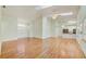 Spacious living room featuring vaulted ceilings, skylights, a ceiling fan and beautiful hardwood floors at 2348 Rolling View Dr, Spring Hill, FL 34606