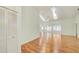 Open living area with hardwood floors, vaulted ceiling, and a view of a sunroom with lots of natural light at 2348 Rolling View Dr, Spring Hill, FL 34606