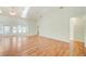 Bright living room with hardwood floors, vaulted ceiling and seamless access to other rooms at 2348 Rolling View Dr, Spring Hill, FL 34606