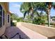 Patio with a view showcasing tropical landscaping and neighborhood greenery at 2348 Rolling View Dr, Spring Hill, FL 34606