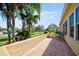 Patio with a relaxing bench, lush greenery, and a charming stone floor at 2348 Rolling View Dr, Spring Hill, FL 34606