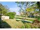 Scenic view of the street and neighborhood, framed by mature trees and lush greenery at 2348 Rolling View Dr, Spring Hill, FL 34606