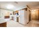 A spacious kitchen featuring wood cabinetry and white appliances with tile flooring at 2430 Catalonia S Way, St Petersburg, FL 33712