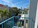 Balcony with a view of tropical community with palm trees and community pool at 247 Rex Pl # G, Madeira Beach, FL 33708