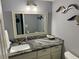 Well-lit bathroom featuring granite counters, modern vanity, and decorative accents at 247 Rex Pl # G, Madeira Beach, FL 33708