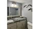 Bathroom with custom granite counters, modern lighting, and decor at 247 Rex Pl # G, Madeira Beach, FL 33708