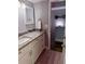 Bathroom vanity featuring granite countertops and modern fixtures at 247 Rex Pl # G, Madeira Beach, FL 33708