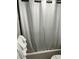 Bathroom with white shower curtain and stack of fresh white towels at 247 Rex Pl # G, Madeira Beach, FL 33708
