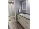 Bathroom featuring granite countertop vanity and shower/tub combination at 247 Rex Pl # G, Madeira Beach, FL 33708