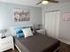 This cozy bedroom features a comfortable queen bed, closet, and light blue walls at 247 Rex Pl # G, Madeira Beach, FL 33708