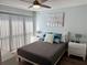 This cozy bedroom features a comfortable queen bed, and light blue walls at 247 Rex Pl # G, Madeira Beach, FL 33708