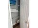 Linen closet with wire shelving, white towels, and blue blankets at 247 Rex Pl # G, Madeira Beach, FL 33708