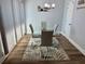 Bright dining room with a glass table, modern chairs, and elegant light fixture at 247 Rex Pl # G, Madeira Beach, FL 33708