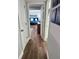 Hallway with wood flooring that leads to a bedroom at 247 Rex Pl # G, Madeira Beach, FL 33708