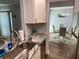 Modern kitchen area with granite counters, stainless steel appliances, and open layout to the dining area at 247 Rex Pl # G, Madeira Beach, FL 33708