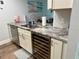 Well-appointed kitchen with granite counters, stainless steel dishwasher, and wine cooler at 247 Rex Pl # G, Madeira Beach, FL 33708