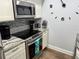 Well-equipped kitchen featuring modern appliances and granite counters, ready for culinary adventures at 247 Rex Pl # G, Madeira Beach, FL 33708