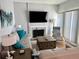 Bright living room featuring a fireplace, sleek furniture, and a modern entertainment setup at 247 Rex Pl # G, Madeira Beach, FL 33708