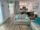 Comfortable living area open to kitchen, showcasing stylish coastal decor and modern furnishings at 247 Rex Pl # G, Madeira Beach, FL 33708