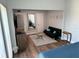 Bright main bedroom boasts wood-look floors, a large mirror, and a sitting area at 247 Rex Pl # G, Madeira Beach, FL 33708